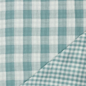 Könnte beinhalten: Ein Nahaufnahme von einem teal- und weiß karierten Stoff. Der Stoff hat eine subtile Textur und ist perfekt für Bastelprojekte.