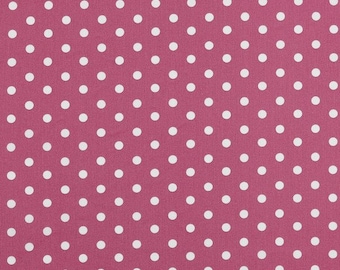 May include: A close-up of a fabric featuring a repeating pattern of white polka dots on a deep pink background. The dots are evenly spaced, creating a classic design. The fabric has a slightly textured appearance.