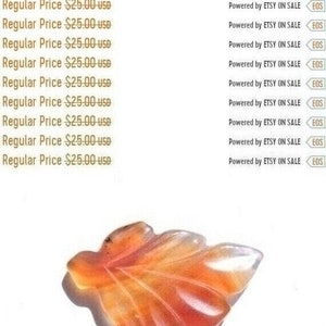 May include: A carved carnelian leaf pendant in shades of orange and red. The pendant is approximately 6.5 cm long and is a natural gemstone.