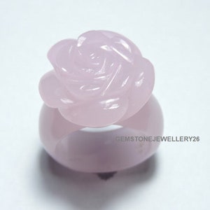 May include: A pink rose carved from rose quartz, set in a ring.