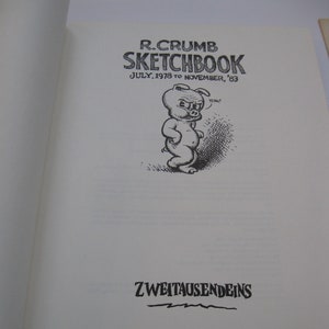 May include: A black and white illustration of a pig with the text "R. Crumb Sketchbook July 1978 to November '83" and "Zweitausendeins" on a white background.