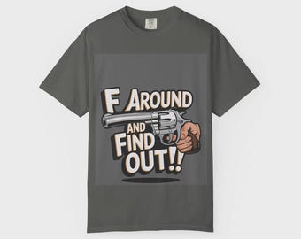 May include: Dark gray t-shirt with the text "F Around and Find Out!!" and a graphic of a revolver held by a hand. The text is in a bold, outlined font.