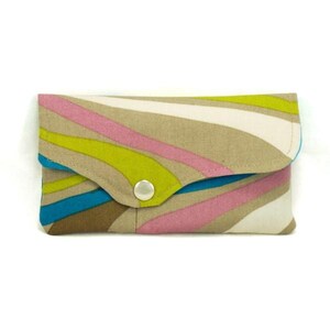 May include: A small, beige fabric clutch with a snap closure. The fabric has a wavy pattern in shades of pink, green, and blue.