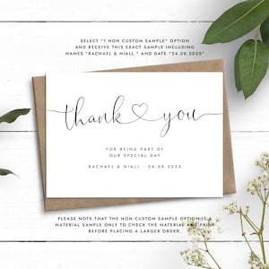 May include: A white thank you card with black text. The card says "thank you" with a heart symbol and "For being part of our special day Rachael & Niall 24.08.2025". The card also includes the text "Please note that the non custom sample option is a material sample only to check the material and print before placing a larger order."