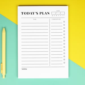 May include: A white notepad with the text "TODAY'S PLAN" and sections for tasks, dates, and checkboxes. A yellow pen lies on a teal and yellow background, beside the notepad. The notepad has lines for tasks and a section to check off when complete.