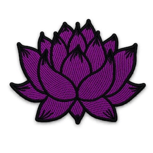 May include: An embroidered patch in the shape of a lotus flower. The design features vibrant purple thread with a distinct black border outlining each petal. The stitching creates a textured appearance throughout the entire floral shape.