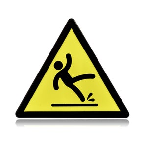Pin de esmalte con señal de advertencia de deslizamiento