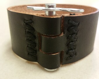 May include: Black leather weightlifting belt with a metal buckle and stitching detail.