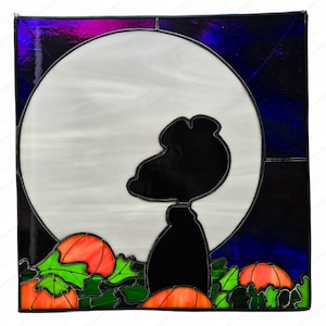 May include: A stained glass window depicting a black silhouette of Snoopy looking up at a full moon with pumpkins in the foreground.