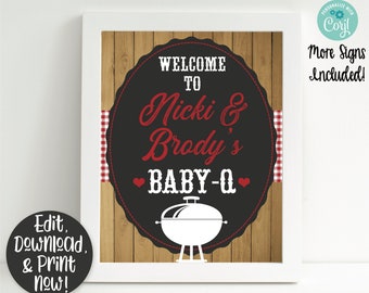 May include: A printable sign set for a baby shower or party. The sign is black with white text and a red heart. The text reads "Welcome to Nicki & Brody's Baby-Q". The sign is framed in a white frame and has a wood background.
