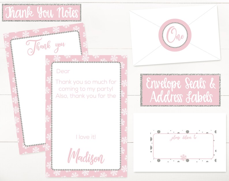 May include: Pink and silver snowflake-themed thank you cards with a white envelope and address labels. The text on the cards reads "Thank you" and "Dear" with space for a personalized message. The envelope has a pink circle with the word "One" in silver glitter. The address labels have a pink background with silver glitter and the text "Envelope Seals & Address Labels".