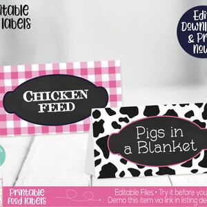 May include: Printable food labels with a pink and white gingham pattern and a black and white cow print pattern. The labels say "Chicken Feed" and "Pigs in a Blanket".