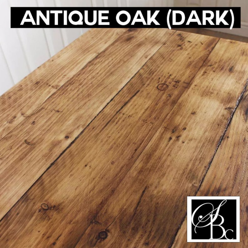 May include: Antique Oak (Dark) wood grain surface. The wood has a dark brown color with a slightly reddish hue. The surface is smooth and polished.