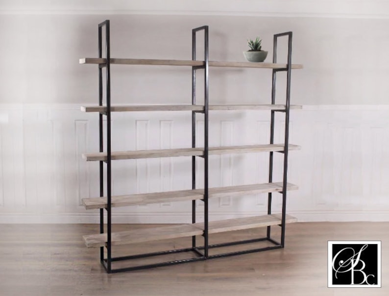 May include: A black metal bookshelf with five wooden shelves. The shelves are made of light-colored wood and have a rustic look. A small potted plant sits on the top shelf.
