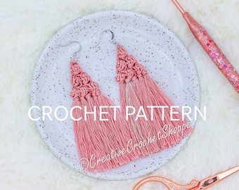 May include: A pair of pink crocheted tassel earrings on a white plate with the text "CROCHET PATTERN" and "@CreativeCrochetShoppe".