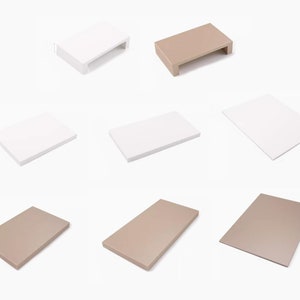 Puede incluir: Conjunto de seis elevadores rectangulares en dos colores: blanco y marrón claro. Los elevadores están hechos de un material liso y tienen un borde ligeramente elevado.