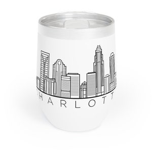 May include: White stainless steel tumbler with a black and white skyline of Charlotte, North Carolina. The text "CHARLOTTE" is printed below the skyline.