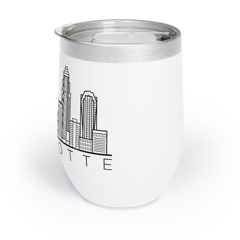 May include: White stainless steel tumbler with a black outline of the Charlotte, North Carolina skyline and the word "LOTTE" printed below.