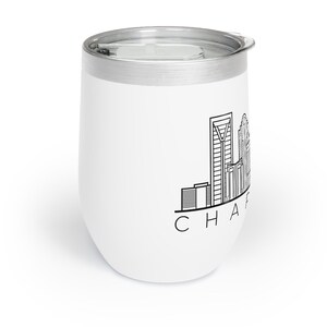 May include: White stainless steel tumbler with a black outline of the Charlotte, North Carolina skyline and the text "CHARLOTTE" underneath.
