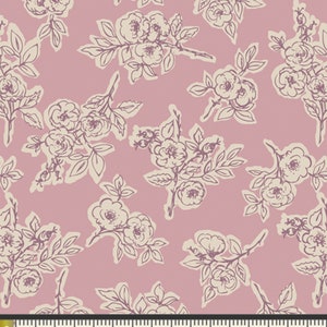 May include: A fabric with a repeating floral pattern. The design features cream-colored rose illustrations with dark purple outlines on a dusty rose background. The pattern includes branches, leaves, and multiple rose blooms. The image includes a ruler with inch measurements.