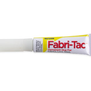 May include: A yellow tube of Fabri-Tac permanent glue for fabrics, lace, and glass. The tube is labeled "BEACON Fabri-Tac Permanent Glue For. Fabrics, Lace, Glass."