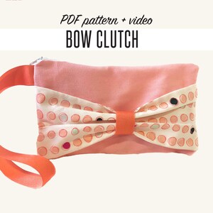 May include: A peach-colored bow clutch with a matching strap. The bow is made of a cream-colored fabric with peach polka dots. The text "PDF pattern + video BOW CLUTCH" is displayed in black font.