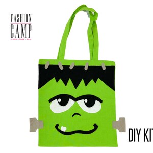Peut inclure: Sac cabas vert avec un visage de Frankenstein. Le sac a une ligne de cheveux noire, des yeux blancs et une bouche cousue. Le sac indique "DIY KIT" dans le coin inf&eacute;rieur droit.
