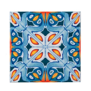 May include: A blue, orange and white ceramic tile with a geometric pattern. The tile has a symmetrical design with a central star shape.