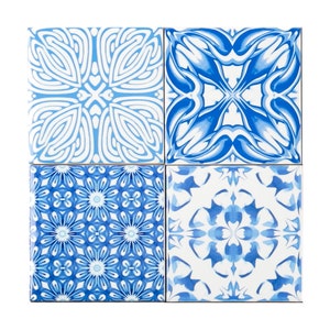 May include: Four square ceramic tiles with blue and white floral patterns. Each tile features a unique design, including stylized flowers and abstract shapes. The tiles are arranged in a 2x2 grid, showcasing the variety of patterns.