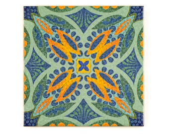 May include: A square ceramic tile with a colorful geometric pattern. The tile features a central motif of four orange and blue leaves, surrounded by a repeating pattern of green, blue, and orange shapes.