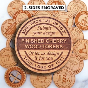 May include: A collection of round cherry wood tokens featuring various laser-engraved designs and text. The central token displays the text 2-SIDES ENGRAVED, SIZES FROM 1.25 INCHES UP TO 3 INCHES, FINISHED CHERRY WOOD TOKENS, and SUBMIT YOUR DESIGN.