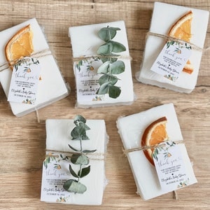 Baby shower soap favors with orange themed customized tag and the option of an orange slice or eucalyptus sprig tied onto the soap favor