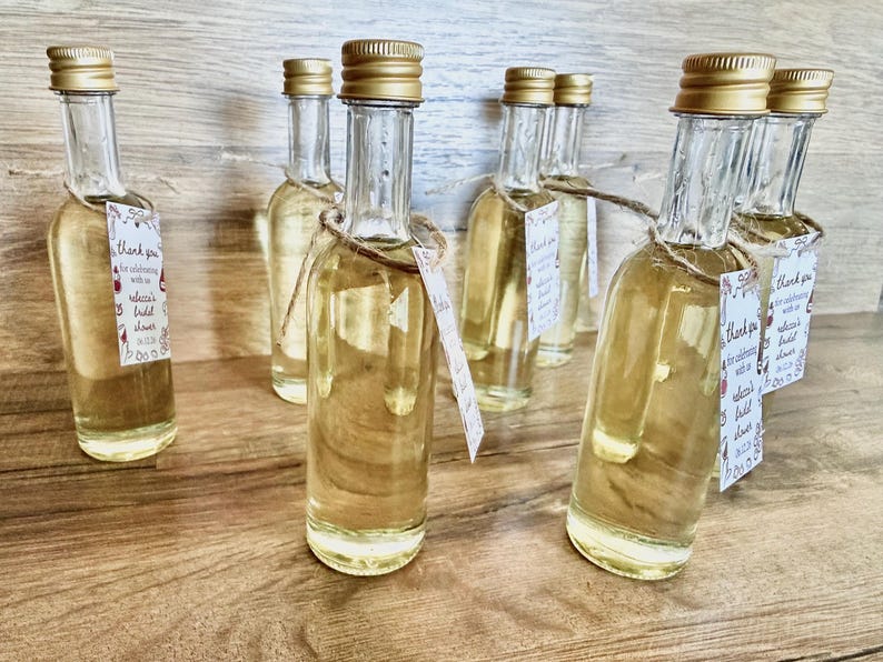”that’s Amore” bridal shower olive oil favors in a clear glass bottle with gold lid