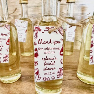 ”that’s Amore” bridal shower olive oil favors in a clear glass bottle with gold lid