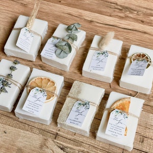 Soap bars for weddings or bridal shower favors with a customized tag with greenery design and multiple soap topping options.