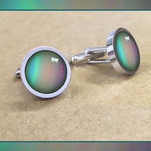 Boutons de manchette Uranus présentés dans une boîte à boutons de manchette noire avec une petite carte photo GRATUITE de qualité. Bijoux d’art spatial.