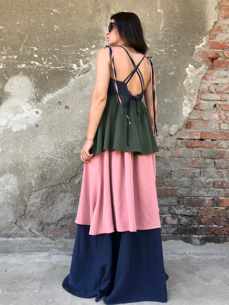 May include: A tiered maxi dress with a green top layer, a pink middle layer, and a navy blue bottom layer. The dress has a criss-cross strap design in the back.