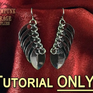 May include: A pair of silver earrings with a chain and multiple teardrop-shaped metal pieces hanging from each earring. The earrings are on a red fabric background. The text "TUTORIAL ONLY!" is at the bottom of the image.