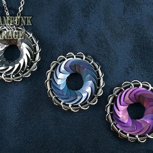 May include: Three silver chainmail rings with a swirling pattern. The rings are in different colors: silver, blue, and purple.