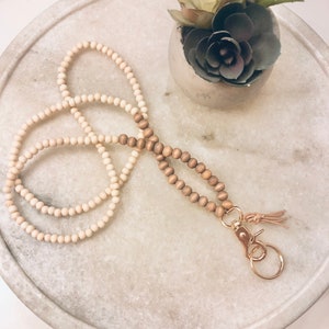 Natural bead lanyard with gold clip with key ring and a leather tassel