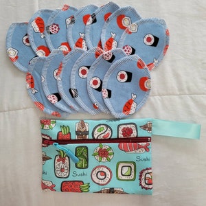 May include: A set of 10 blue cotton rounds with a sushi design. The rounds are arranged in a circle with the design facing outwards. The design features various sushi rolls, including nigiri, maki, and sashimi. The rounds are perfect for removing makeup or applying toner.