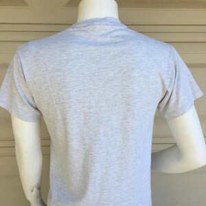 May include: A heather grey short-sleeved t-shirt.