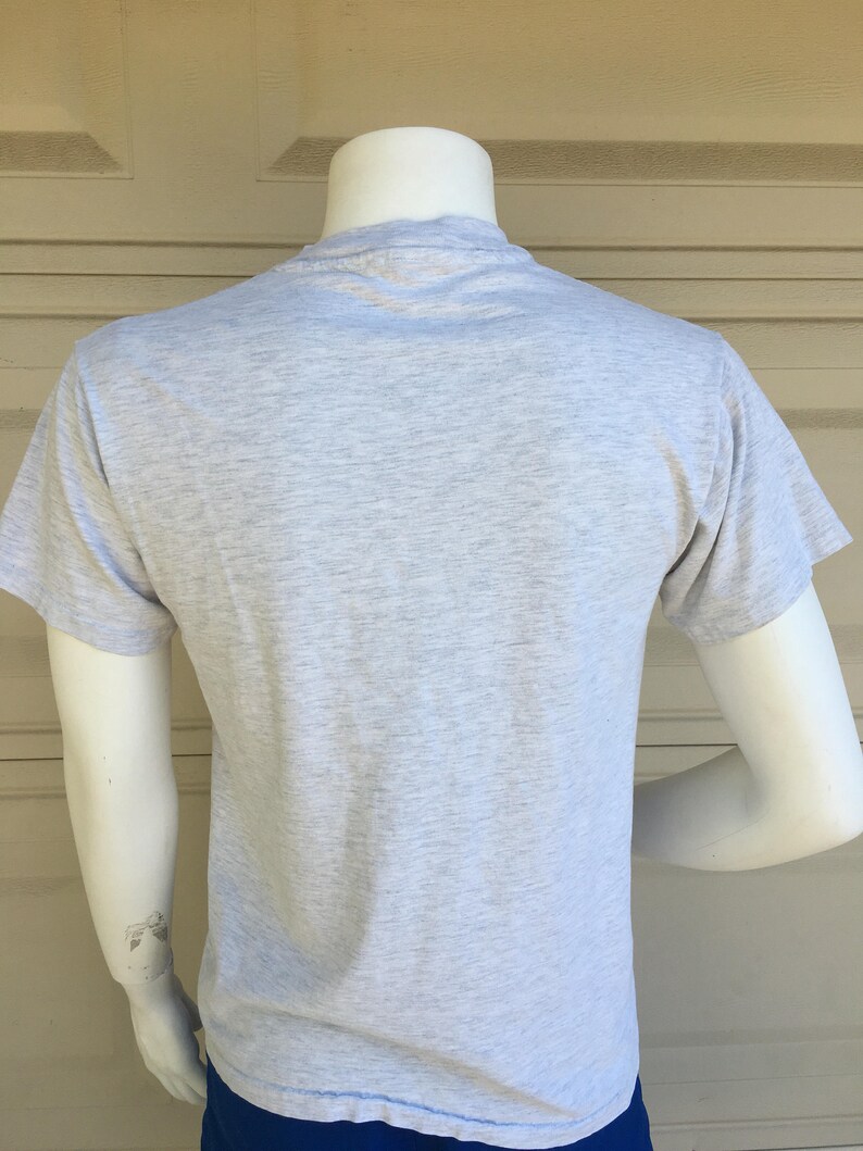 May include: A heather grey short-sleeved t-shirt.