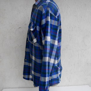 May include: A blue, white, and green plaid long-sleeve shirt with a button-down collar.