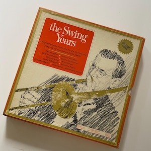 May include: Vintage "The Swing Years" collector's edition box set. The box features an illustration of a musician playing a trombone. The text on the box reads "Original performances by 24 top bands playing 72 top tunes (1936-1946)".