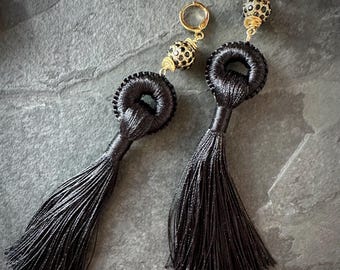 Black tassel earrings with gold huggy hoop earrings