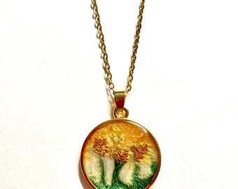 Collar con colgante de resina de perla verde abstracta de inspiración natural, bisel dorado y cuentas de cobre.