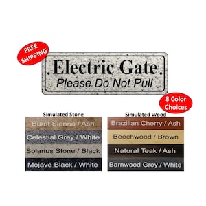 May include: A rectangular sign with the text "Electric Gate. Please Do Not Pull" in black lettering on a gray background. The sign is available in eight color choices: Burnt Sienna / Ash, Celestial Grey / White, Solarius Stone / Black, Mojave Black / White, Brazilian Cherry / Ash, Beechwood / Brown, Natural Teak / Ash, and Barnwood Grey / White.