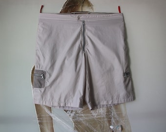 May include: Light gray cargo shorts with zippered pockets and mesh accents.