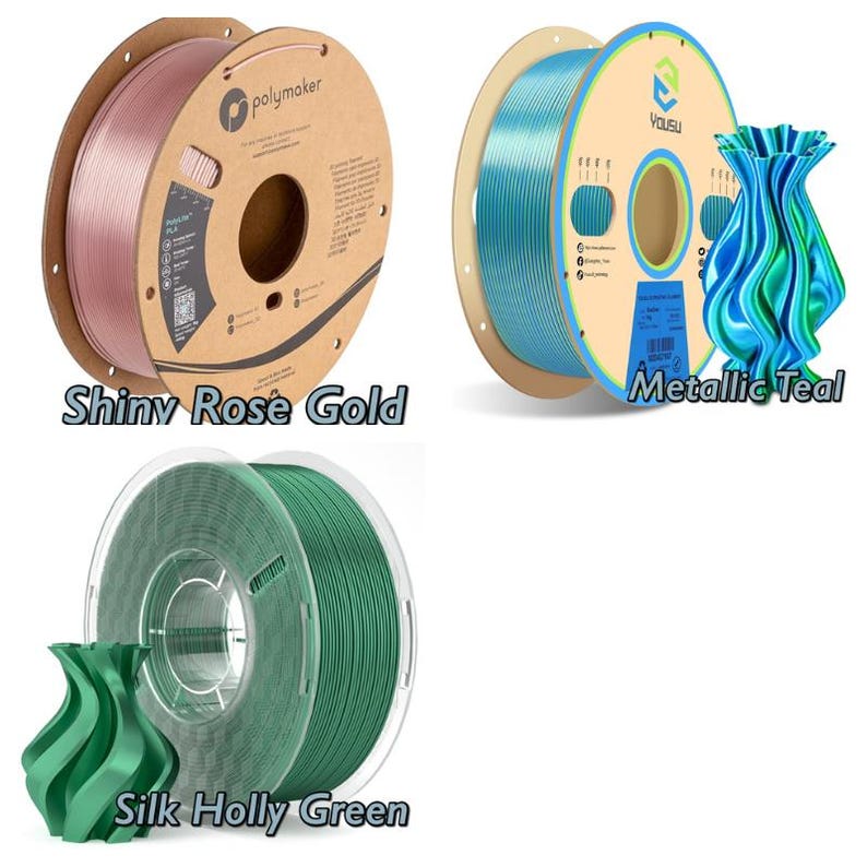 May include: Three spools of filament for 3D printing. The first spool is rose gold and labeled "Shiny Rose Gold". The second spool is teal and labeled "Metallic Teal". The third spool is green and labeled "Silk Holly Green".